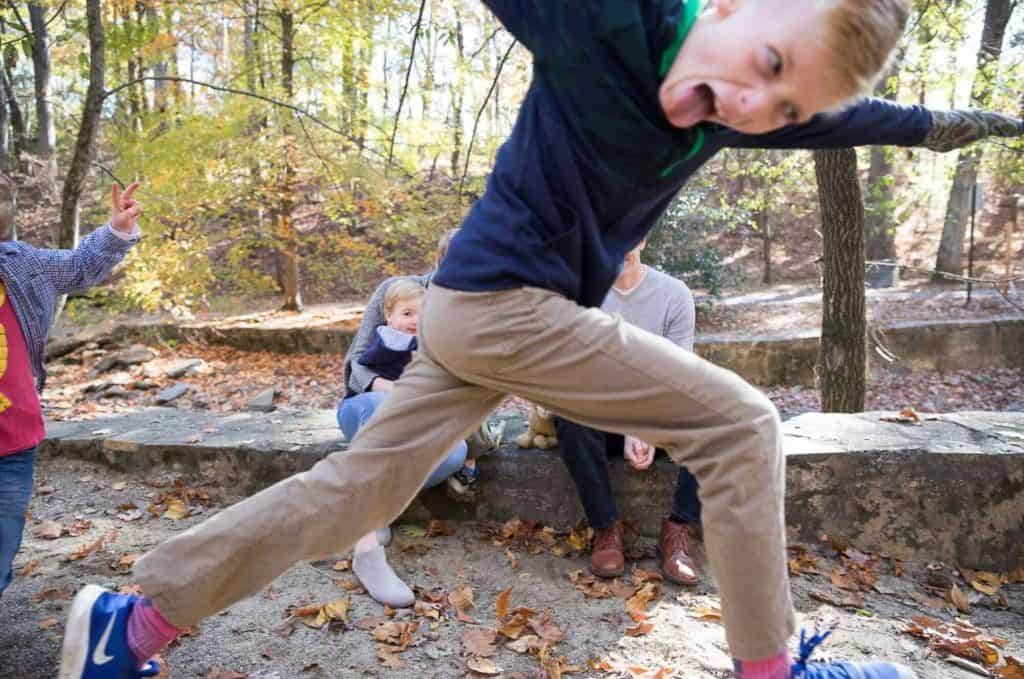 a boy "photo bombs" the family with his tongue out