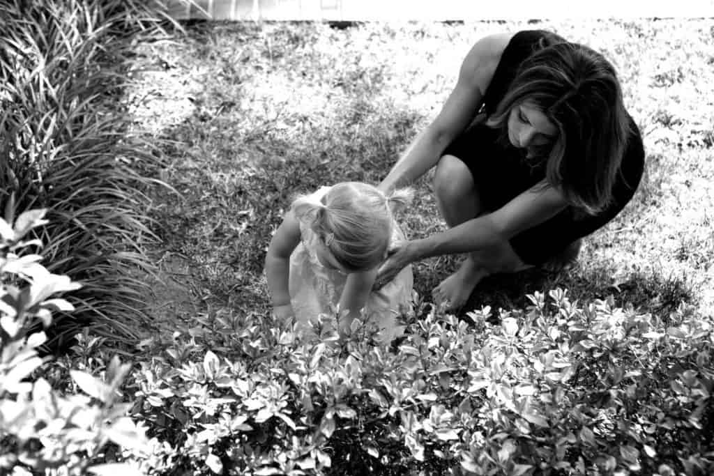a mom gardens with her toddler